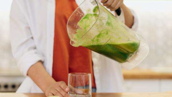 Mujer con smoothie verde